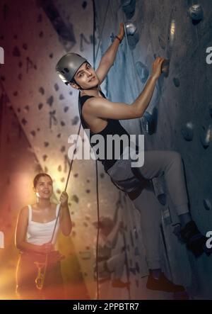 Determined young man in safety helmet doing his best at climbing artificial wall Stock Photo