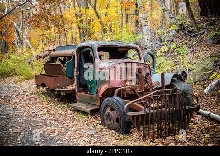 Decaying compressor truck at an abandoned granite quarry in Massachusetts Stock Photo
