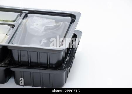 plastic food container with sushi from restaurant on isolated background, takeaway food order Stock Photo