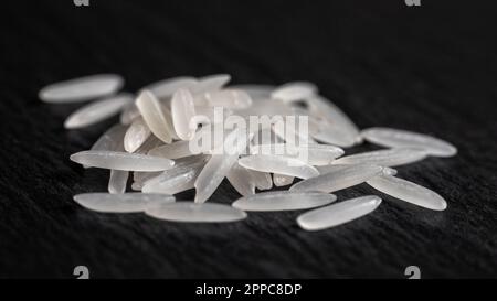 White rice on a black graphite stone slab, healthy food Stock Photo - Alamy