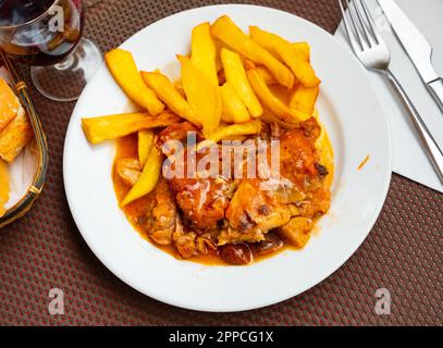 Braised rabbit served with potato garnish Stock Photo