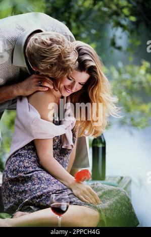 Older Caucasian man embracing his beautiful young girlfriend Stock Photo