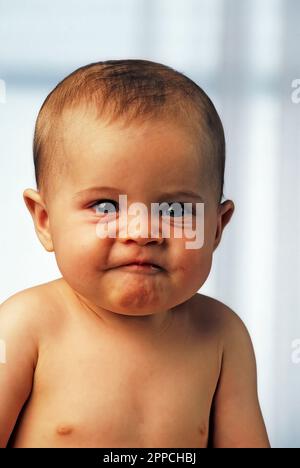 Caucasian baby with a funny expression Stock Photo