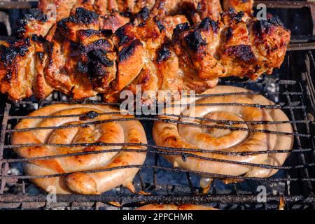 Shish kebab of meat skewered on a grill close-up outdoors Stock Photo -  Alamy