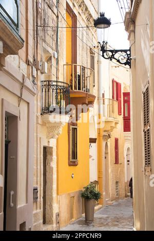 Rabat, Malta - November 13, 2022: Picturesque and colorful Mediterranean pedestrian street with stone houses and balconies Stock Photo