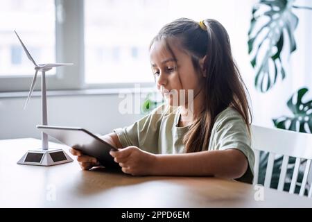 Girl using tablet PC sitting at home Stock Photo