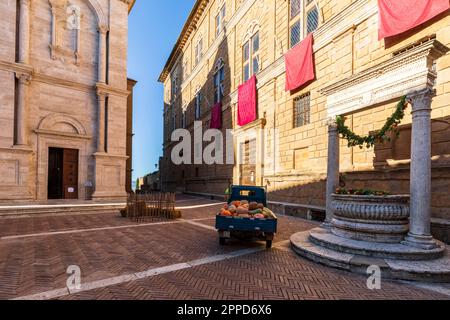 Italy, Tuscany, Pienza, Piaggio ape parked in front of Fontana del Palazzo Piccolomini Stock Photo