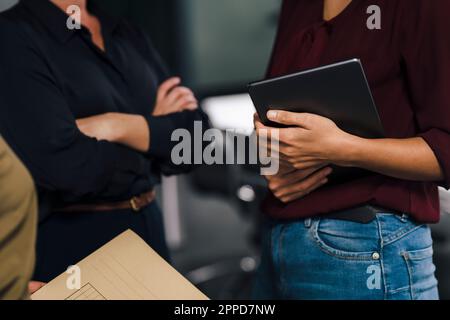 Businesswoman holding tablet PC with colleagues in office Stock Photo