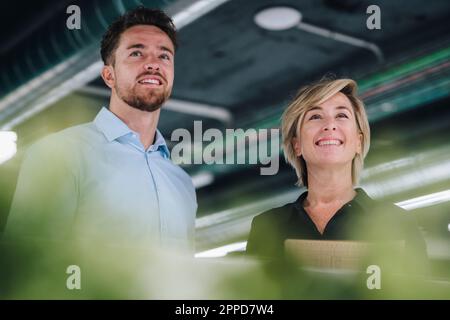 Happy business people standing together in office Stock Photo