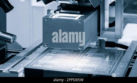 Close up of examining of test sample of microchip transistor under the microscope in laboratory. Equipment for testing microchips. Automation of produ Stock Photo