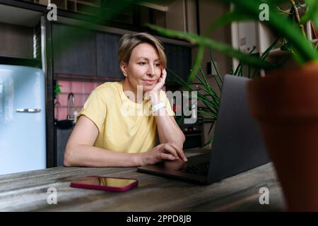 Mature woman using laptop at home Stock Photo
