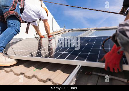 Engineer with colleague installing solar panel Stock Photo