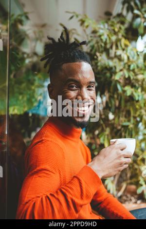 Happy young man holding coffee cup Stock Photo