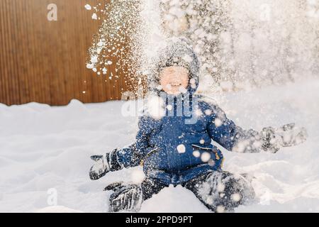 Happy boy enjoying in snow Stock Photo