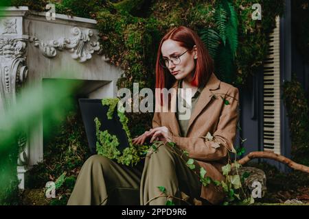 Redhead freelancer working on laptop Stock Photo