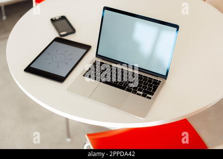 Electric gadgets on table in office Stock Photo