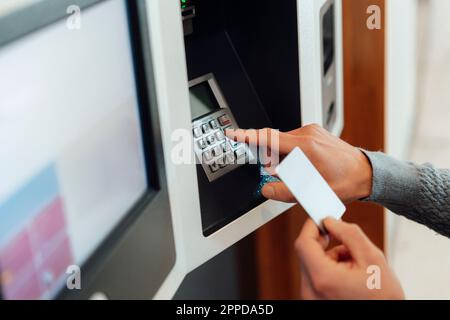 Man withdrawing cash from ATM machine Stock Photo