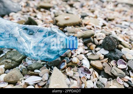 Plastic bottle with seashells at beach Stock Photo