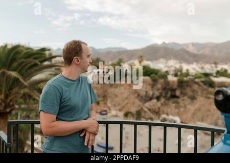 Thoughtful man standing by railing Stock Photo