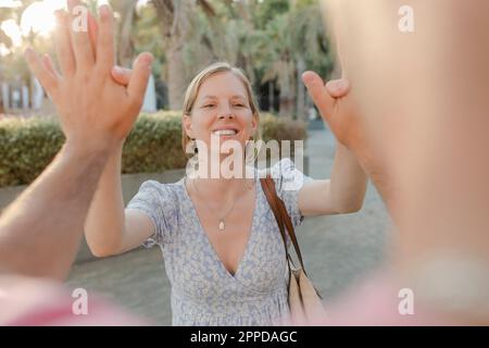 Happy woman giving high-five to man Stock Photo