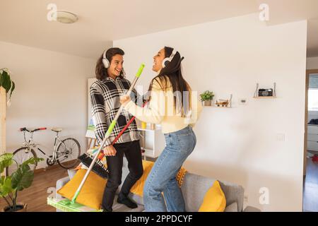 Happy couple having fun doing housework Stock Photo