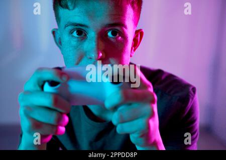 Thoughtful young man playing video game Stock Photo
