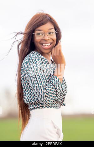 Happy young woman with long brown hair Stock Photo
