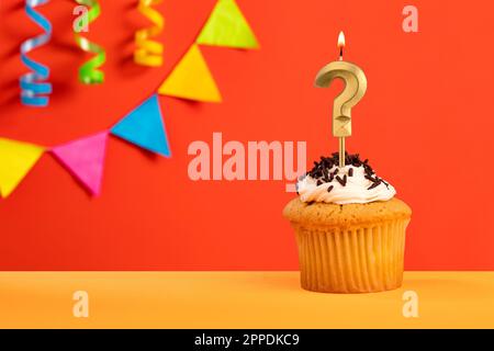 Question mark candle - Birthday cake on orange background with bunting Stock Photo