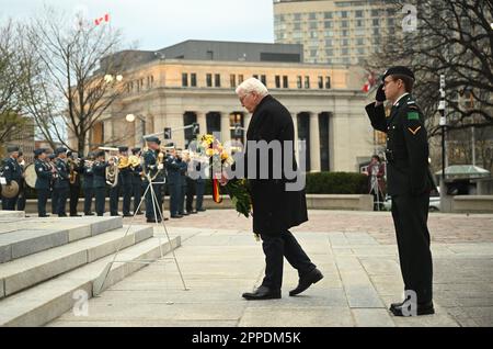 Ottawa, Canada. 23rd Apr, 2023. German President Frank-Walter Steinmeier (r) lays a wreath at the Tomb of the Unknown Soldier at the Confederation Square National War Memorial. The aim of the trip is to strengthen German-Canadian relations in difficult political and economic times. Credit: Britta Pedersen/dpa/Alamy Live News Stock Photo