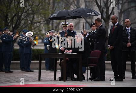 Ottawa, Canada. 23rd Apr, 2023. Federal President Frank-Walter Steinmeier and his wife Elke Büdenbender sign the guest book. The aim of the trip is to strengthen German-Canadian relations in difficult political and economic times. Credit: Britta Pedersen/dpa/Alamy Live News Stock Photo