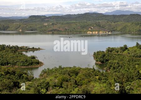 Landscape of Kampar River with hills and forest on its banks is photographed near Bangkinang in Kampar regency, Riau, Indonesia. Stock Photo