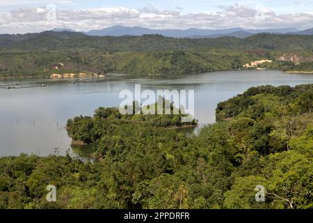 Landscape of Kampar River with hills and forest on its banks is photographed near Bangkinang in Kampar regency, Riau, Indonesia. Stock Photo