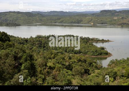 Landscape of Kampar River with hills and forest on its banks is photographed near Bangkinang in Kampar regency, Riau, Indonesia. Stock Photo