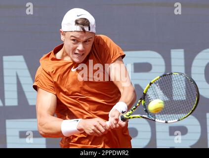 Munich, Germany. 23rd Apr, 2023. Holger Rune of Denmark hits a return to Botic van de Zandschulp of the Netherlands during the men's singles final match at the BMW Open 2023 in Munich, Germany, on April 23, 2023. Credit: Philippe Ruiz/Xinhua/Alamy Live News Stock Photo