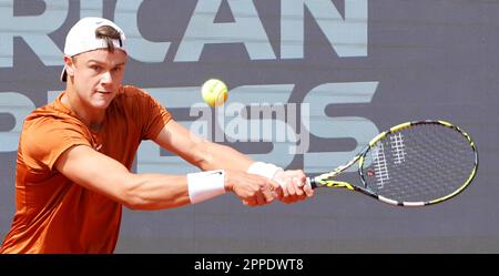 Munich, Germany. 23rd Apr, 2023. Holger Rune of Denmark hits a return to Botic van de Zandschulp of the Netherlands during the men's singles final match at the BMW Open 2023 in Munich, Germany, on April 23, 2023. Credit: Philippe Ruiz/Xinhua/Alamy Live News Stock Photo