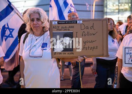 Tel Aviv, Israel. 22nd Apr, 2023. Yaara (49) daughter of Alex Gur-Arie, who died as a soldier at the 73í Yom Kippur war, holds a poster of her and her father's photo during an anti judicial overhaul demonstration in Tel Aviv. Credit: SOPA Images Limited/Alamy Live News Stock Photo