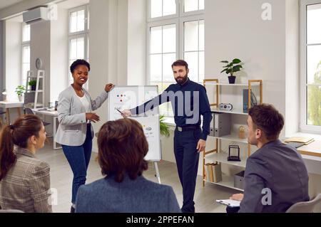 Multiracial people team employees of progressive company oversees presentation in spacious office Stock Photo