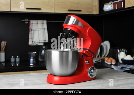 White kitchen machine and stand mixer on a wooden table in a bright design  apartment Stock Photo - Alamy