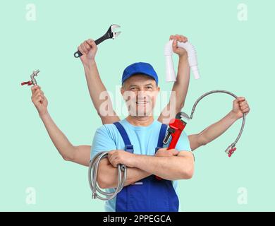 Plumber with different tools on light blue background. Multitasking handyman Stock Photo