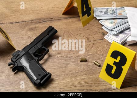 Gun, money and shell casings on wooden background. Crime scene Stock Photo