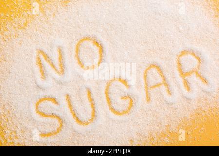 Phrase No Sugar made of granules on yellow background, flat lay Stock Photo