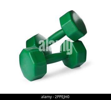 Green dumbbells on white background. Weight training equipment Stock Photo