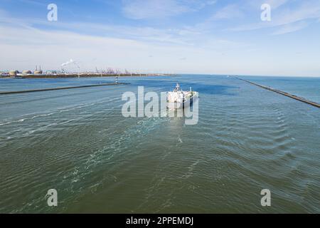 a tanker ship sailing into the sea near Botlek Netherlands aerial drone shot. High quality photo Stock Photo