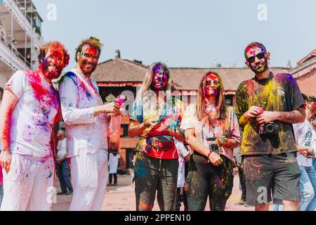 KATHMANDU, NEPAL - MARCH 6, 2023: Tourists enjoying Happy Holi festival at Basantapur Durbar Square in Kathmandu. Holi is a spring festival celebrated Stock Photo