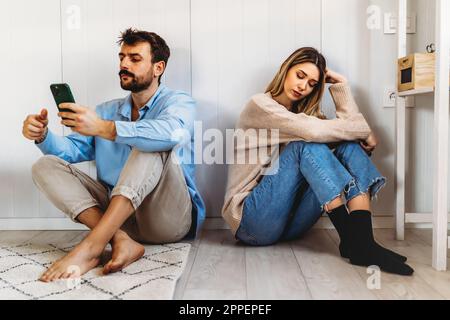 Gadget addiction and relationship problems. Couple with smartphones ignoring each other Stock Photo