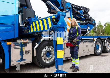Blond female truck driver standing next to truck Stock Photo - Alamy