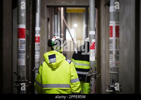 Engineers walking at construction site Stock Photo
