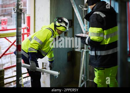 Male and female engineer working at construction site Stock Photo