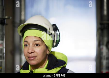 Female engineer in hard hat at construction site Stock Photo