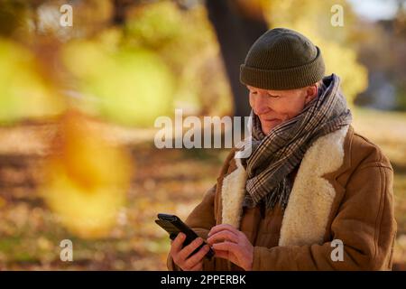 Senior man using cell phone Stock Photo